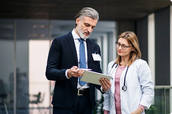Lawyer and doctor reviewing tablet information