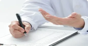 Doctor writing on medical form